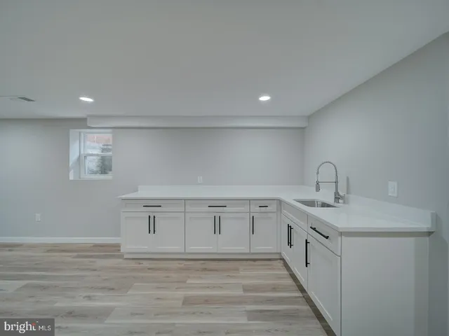 a bathroom with a toilet sink vanity and mirror
