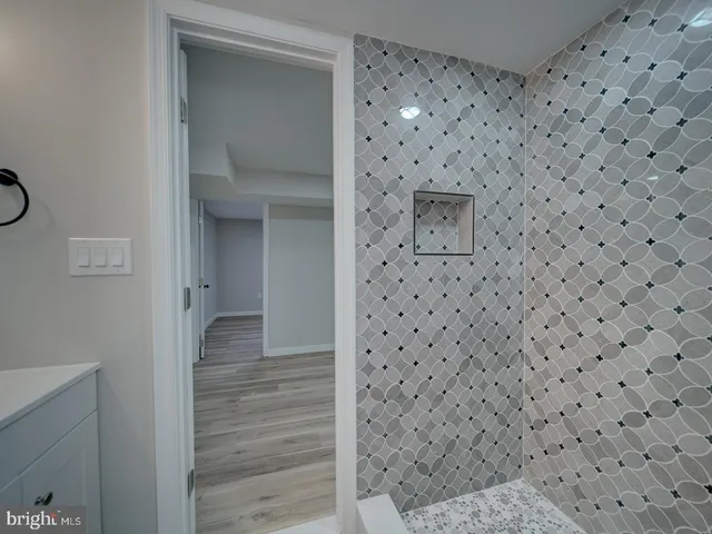 a view of an empty room with wooden floor