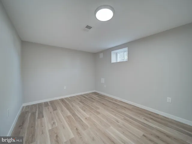a view of an empty room and wooden floor