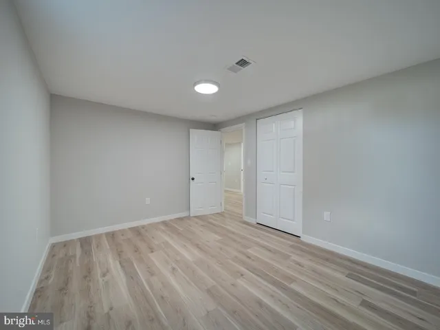 a front view of house with yard and trees in the background