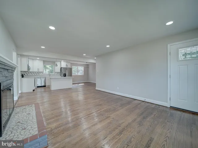 a kitchen with kitchen island white cabinets appliances and center island