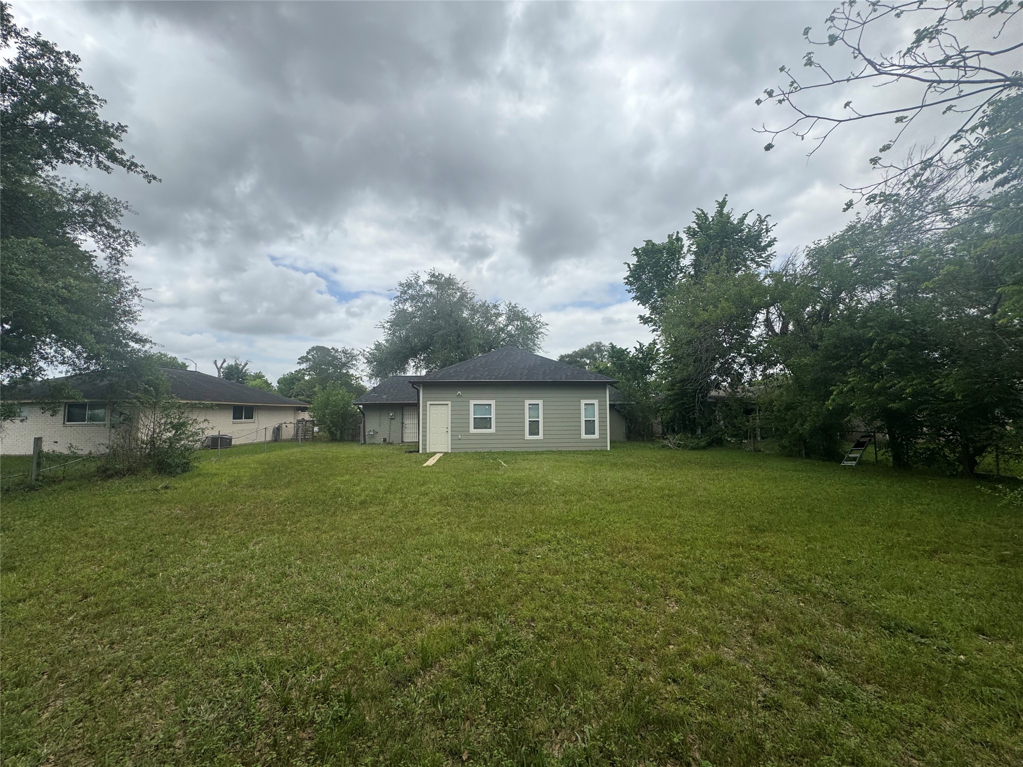 1443 Willow Rock Road Houston, TX 77088 - Photo 27 of 27 a view of a big yard with a house in the background