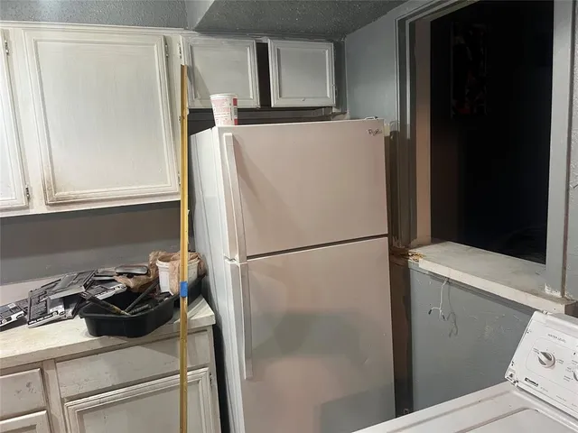 a white refrigerator freezer sitting inside of a kitchen
