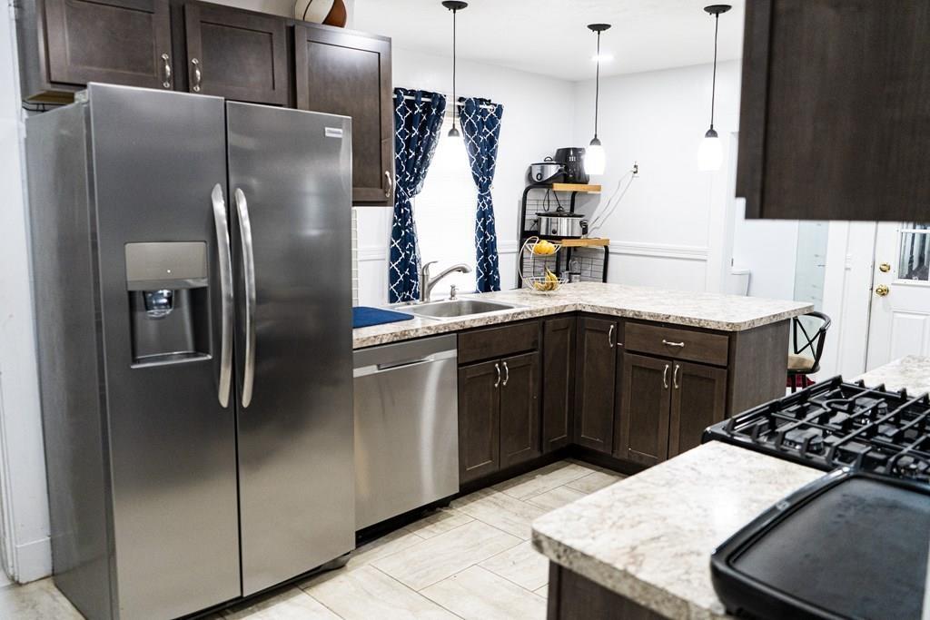 107 Ranney Street Springfield, MA 01108 - Photo 6 of 21 a kitchen with stainless steel appliances granite countertop a sink stove and refrigerator