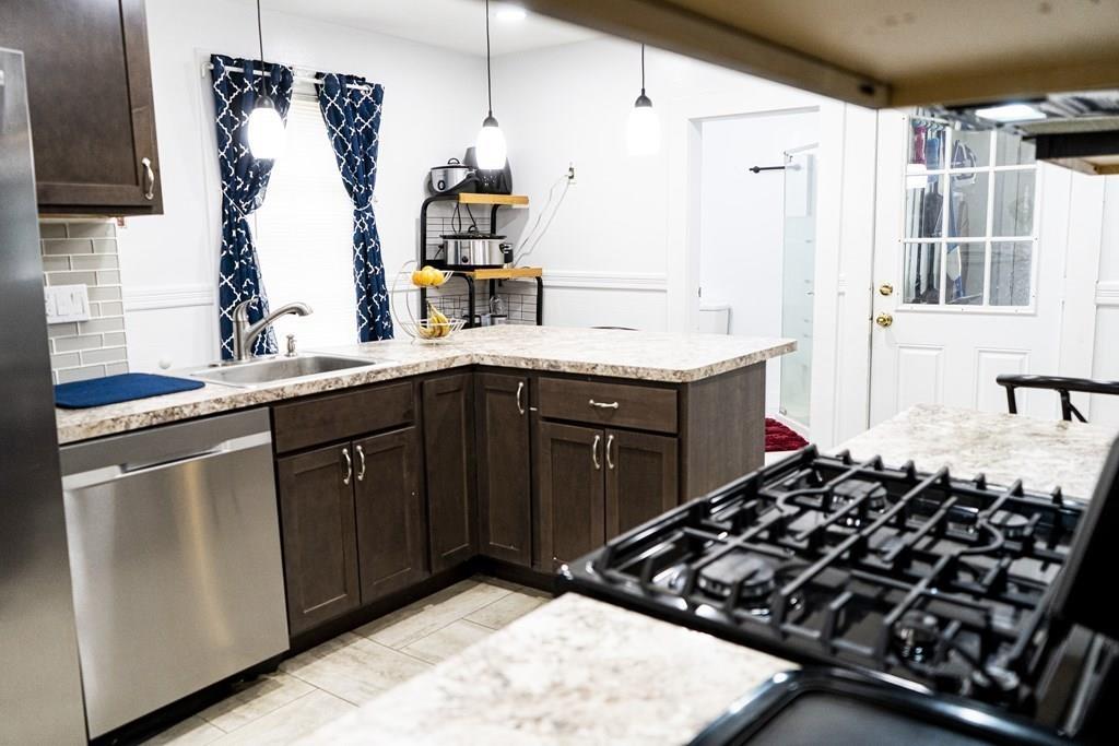 107 Ranney Street Springfield, MA 01108 - Photo 7 of 21 a kitchen with a sink stove and refrigerator