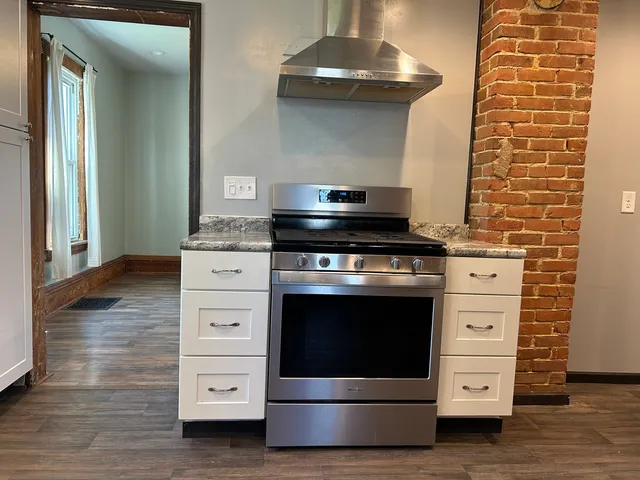 a stove top oven sitting inside of a kitchen
