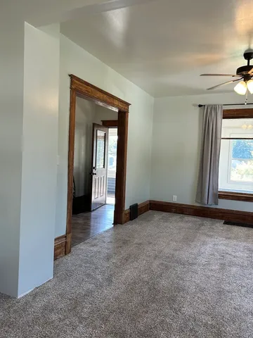 an empty room with windows and closet