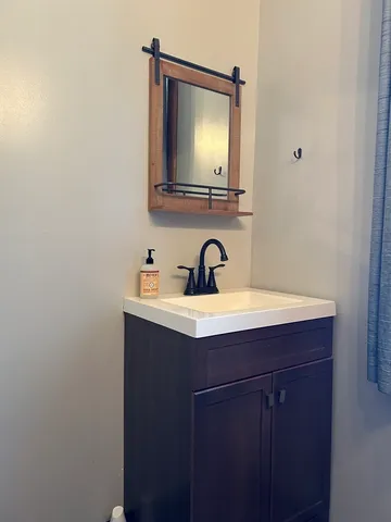 a bathroom with a sink and a mirror