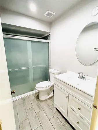 a bathroom with a toilet sink and shower