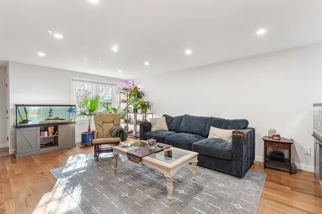 a living room with furniture a window and a flat screen tv