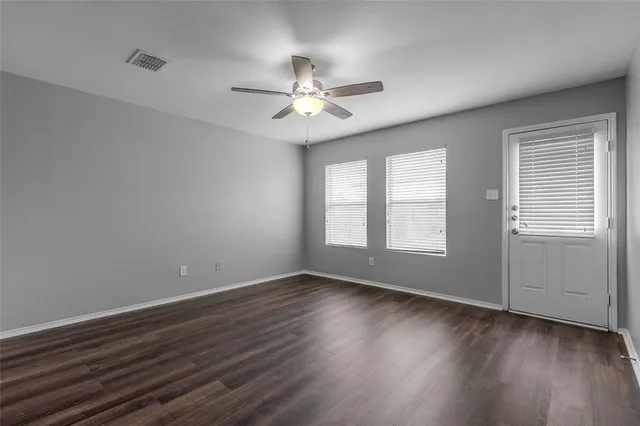 wooden floor in an empty room with a window