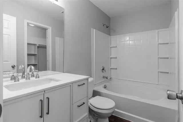 a bathroom with a sink toilet tub and vanity