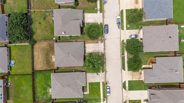 an aerial view of multiple houses with a yard