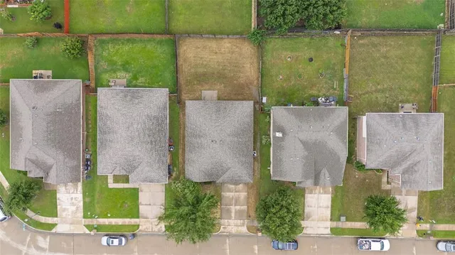 an aerial view of a house with a yard and lake view