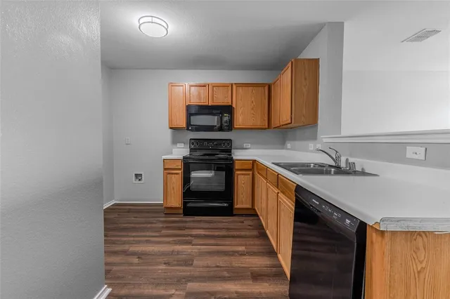 a kitchen with kitchen island a sink stove and cabinets