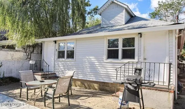 a backyard of a house with table and chairs