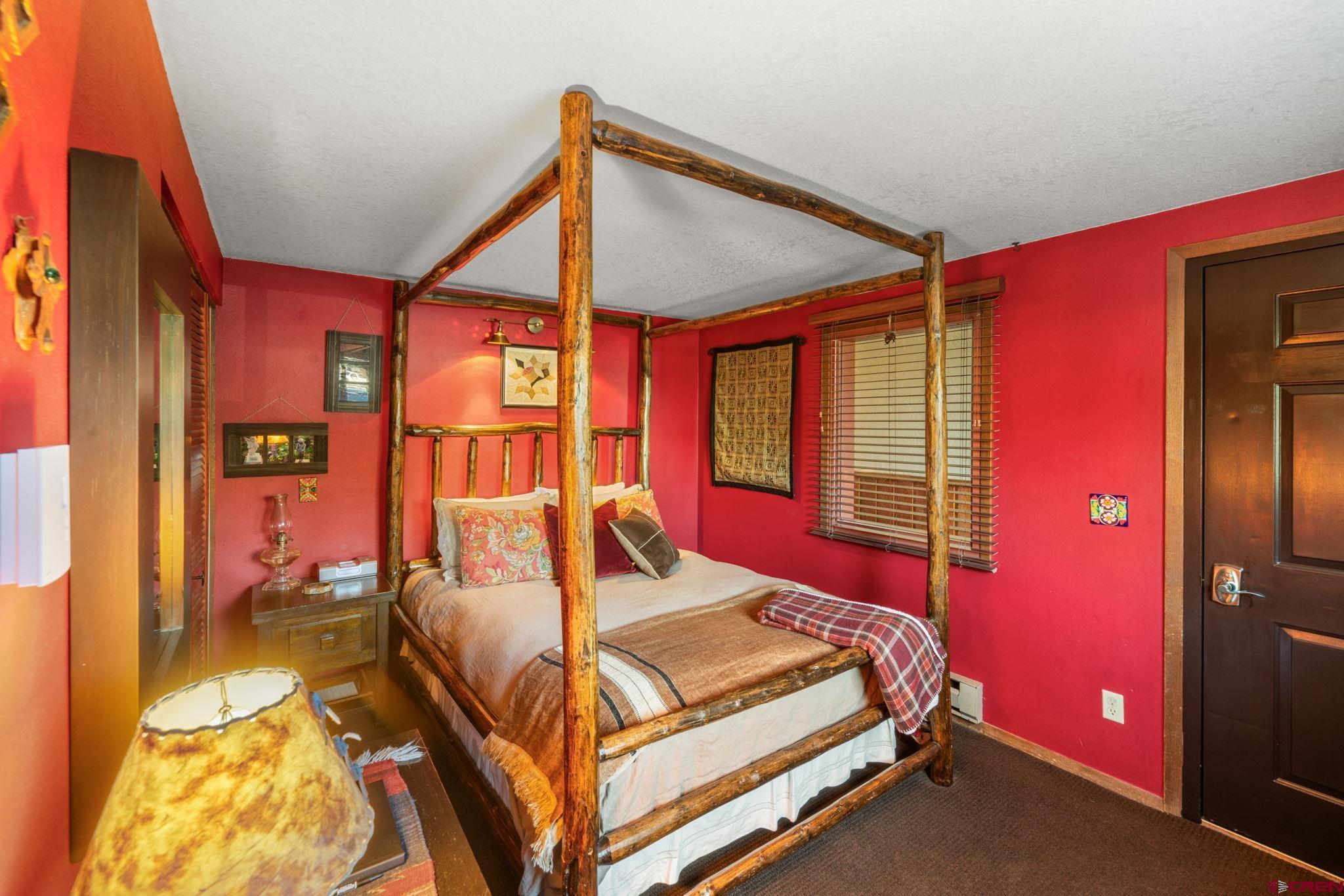 701 Gothic Road, Unit 143 Crested Butte, CO 81225 - Photo 11 of 30 a bedroom with a bed and wooden floor