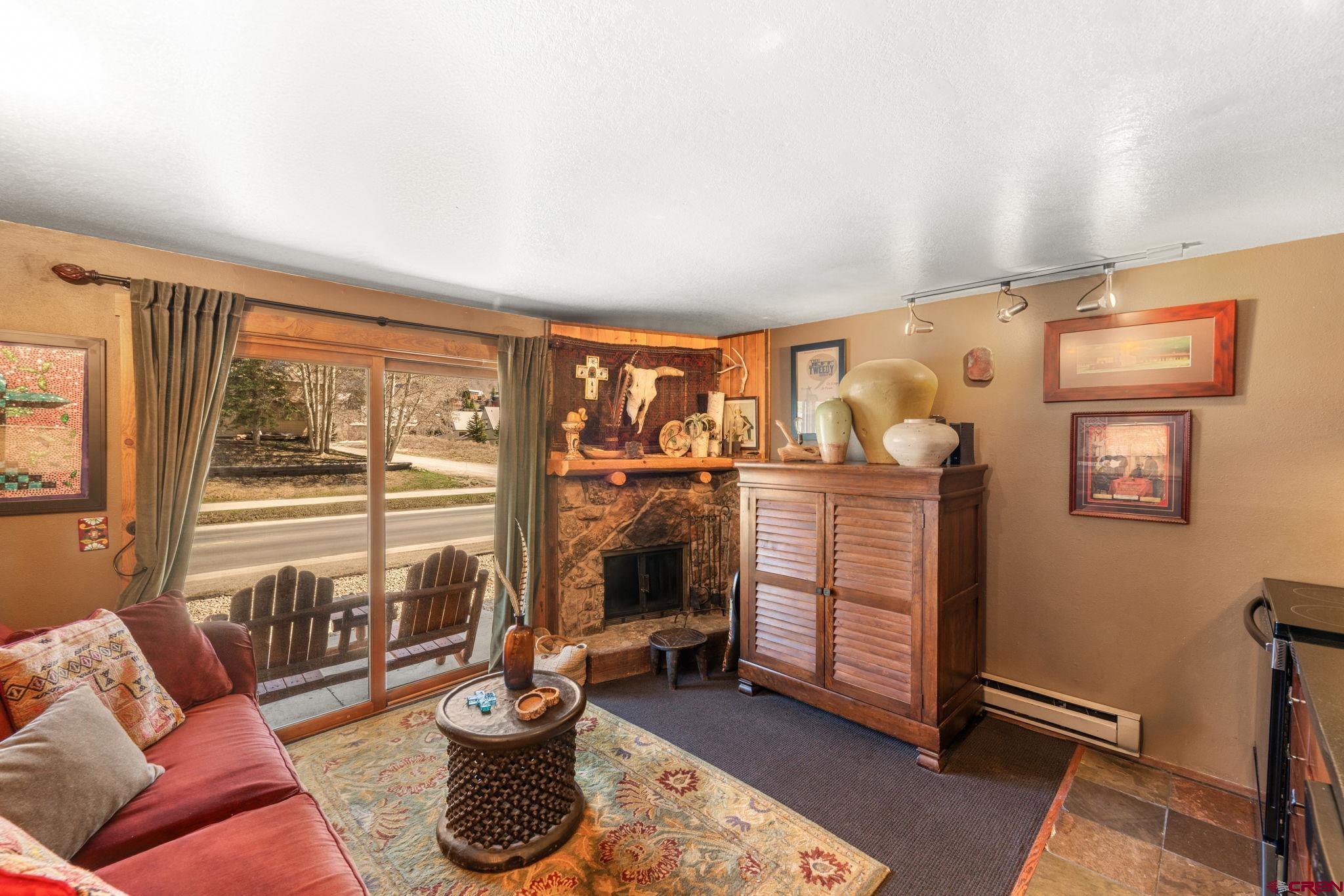 701 Gothic Road, Unit 143 Crested Butte, CO 81225 - Photo 2 of 30 a living room with furniture and a floor to ceiling window