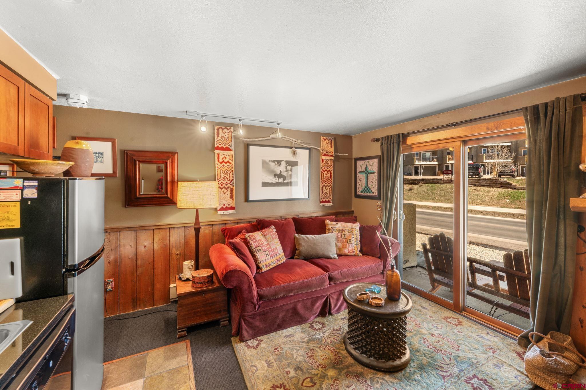 701 Gothic Road, Unit 143 Crested Butte, CO 81225 - Photo 3 of 30 a living room with furniture and a flat screen tv