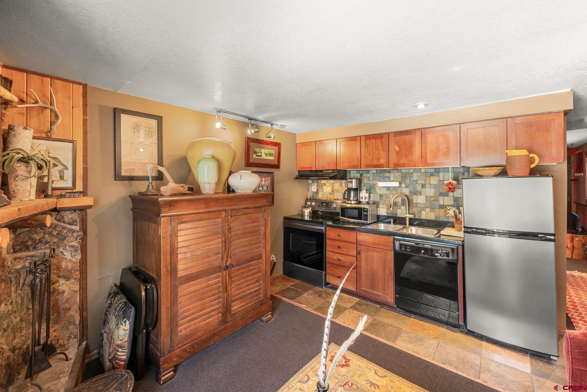 701 Gothic Road, Unit 143 Crested Butte, CO 81225 - Photo 7 of 30 a kitchen with stainless steel appliances granite countertop a refrigerator and a stove