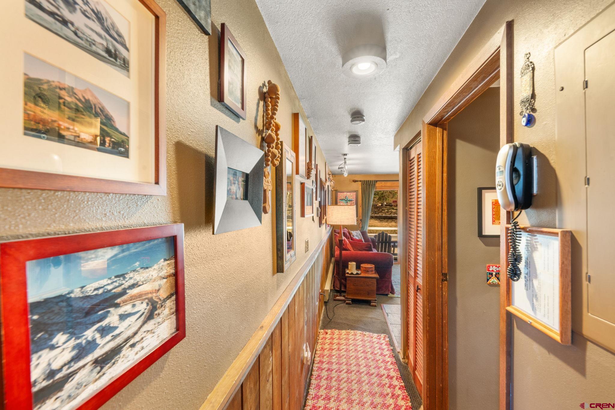701 Gothic Road, Unit 143 Crested Butte, CO 81225 - Photo 10 of 30 a hallway with painting on the wall and a large window