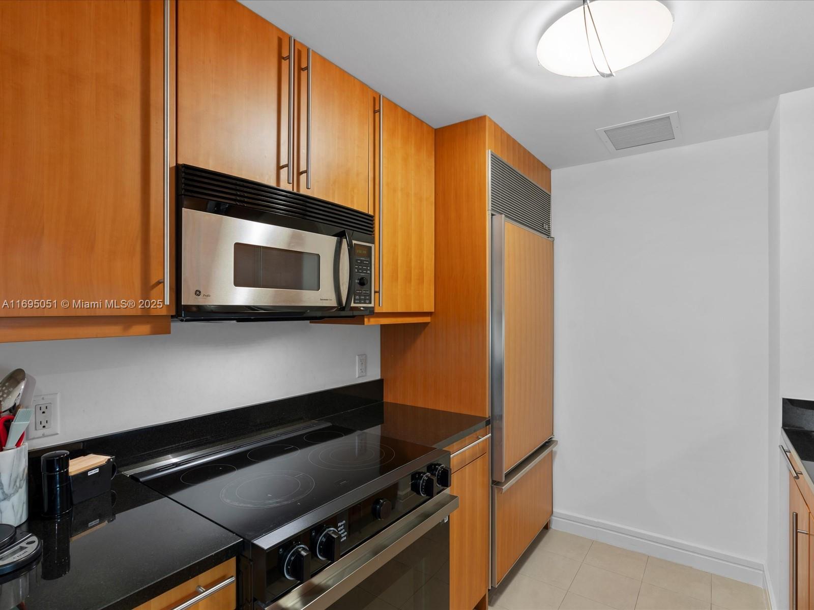 1435 Brickell Avenue, Unit 3601 Miami, FL 33131 - Photo 16 of 42 a kitchen with stainless steel appliances a stove and a microwave