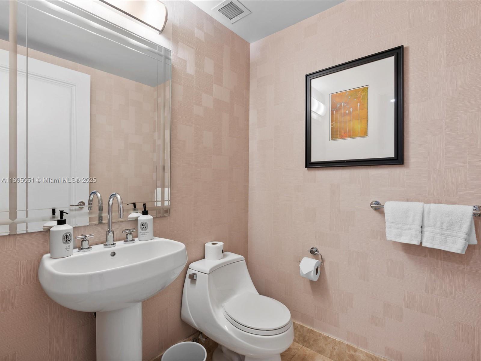 1435 Brickell Avenue, Unit 3601 Miami, FL 33131 - Photo 18 of 42 a bathroom with a toilet a sink and mirror