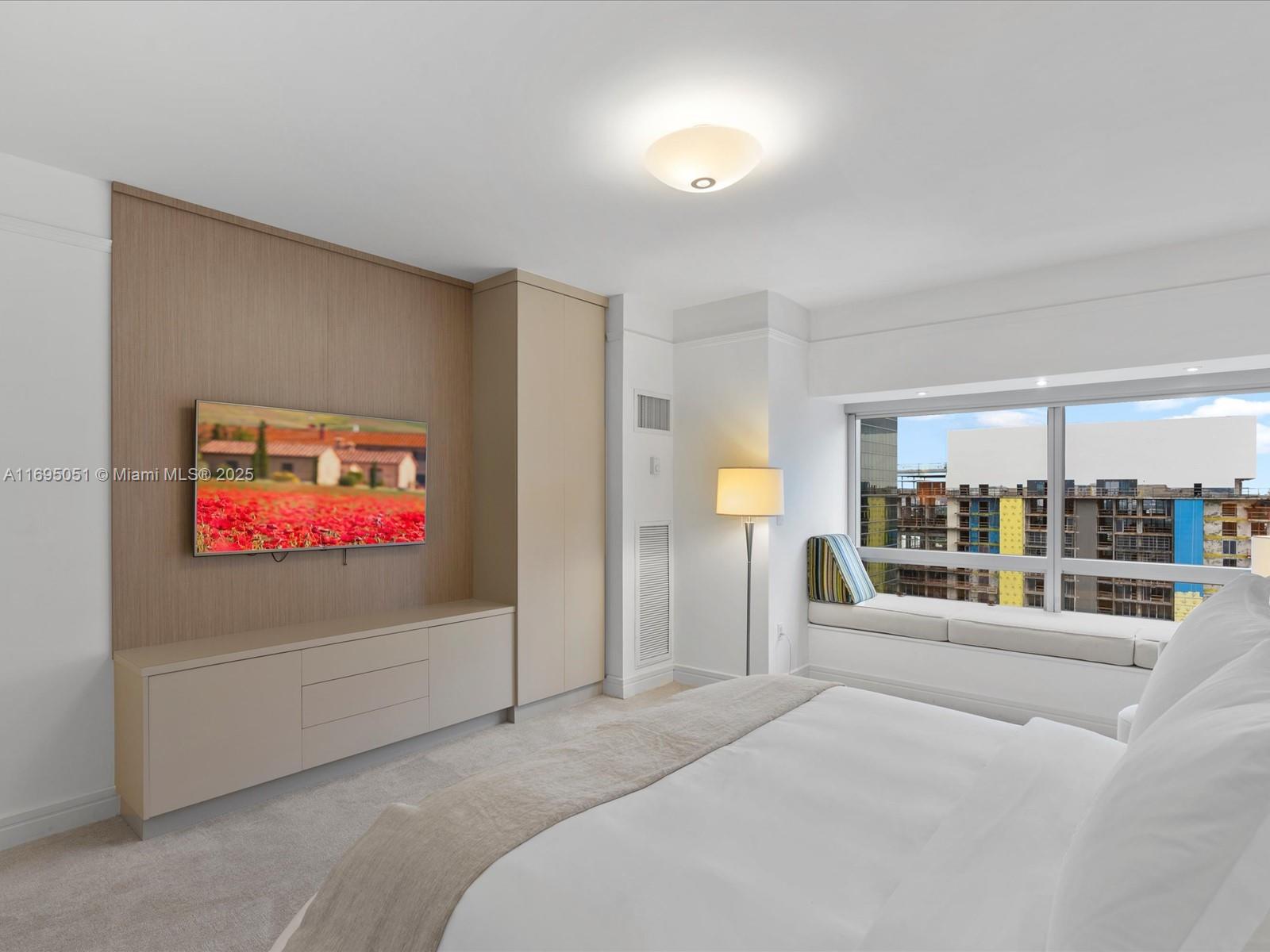 1435 Brickell Avenue, Unit 3601 Miami, FL 33131 - Photo 23 of 42 a bedroom with a bed and a large window