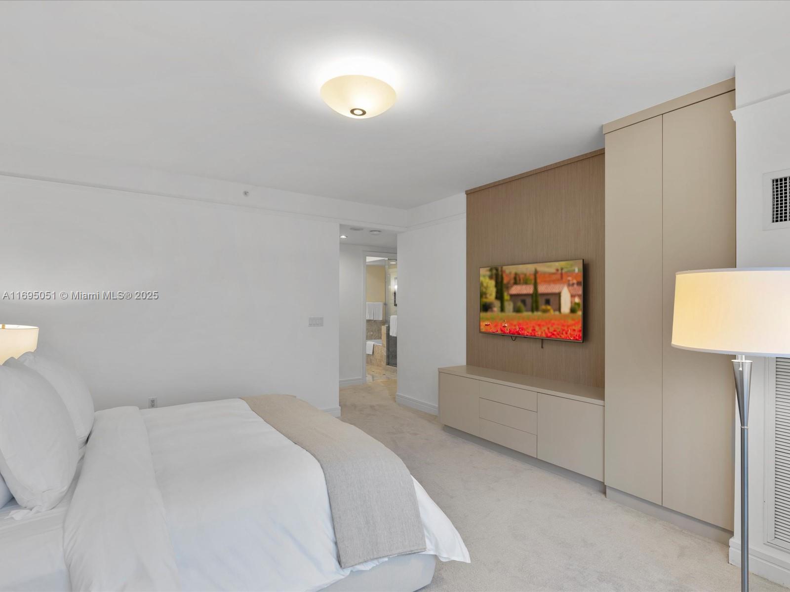 1435 Brickell Avenue, Unit 3601 Miami, FL 33131 - Photo 25 of 42 a bedroom with furniture and a flat screen tv