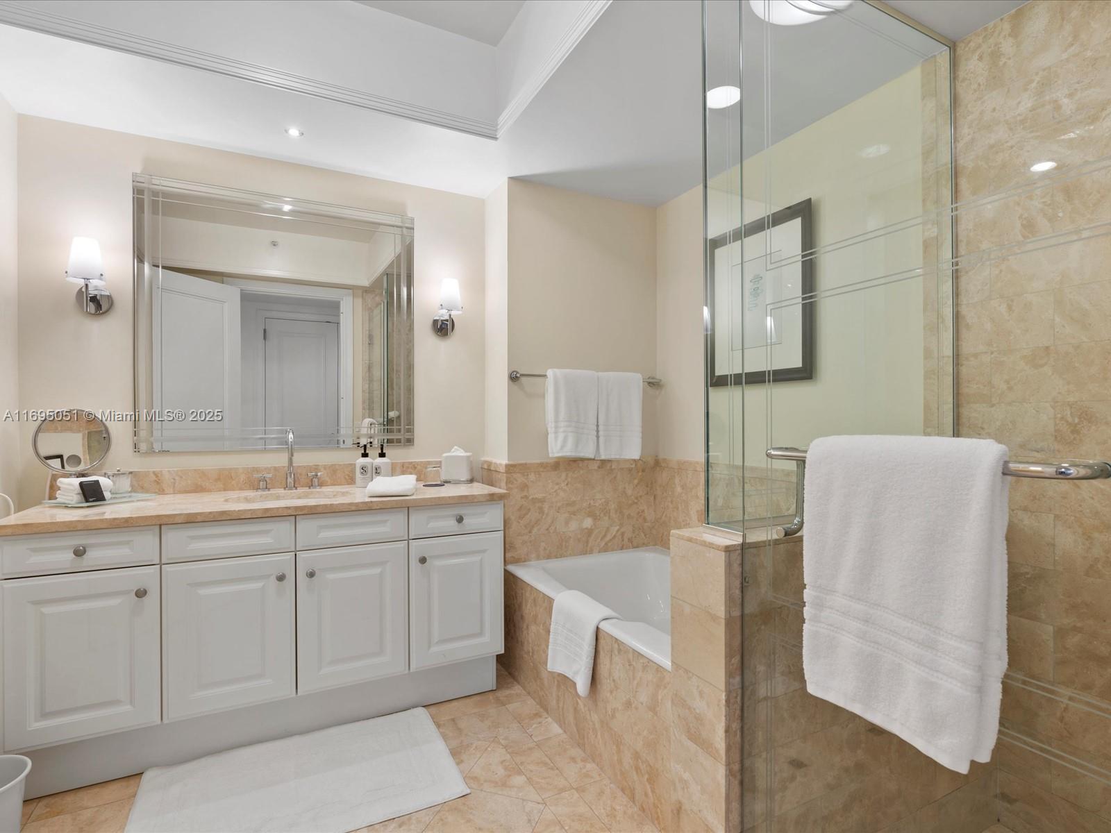 1435 Brickell Avenue, Unit 3601 Miami, FL 33131 - Photo 26 of 42 a spacious bathroom with a double vanity sink mirror and bathtub