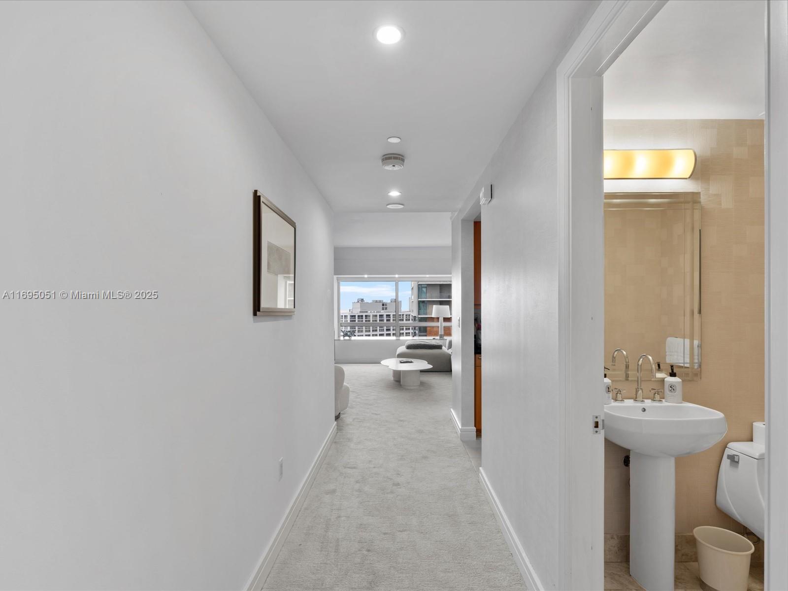 1435 Brickell Avenue, Unit 3601 Miami, FL 33131 - Photo 3 of 42 a view of a hallway with a couch and chandelier