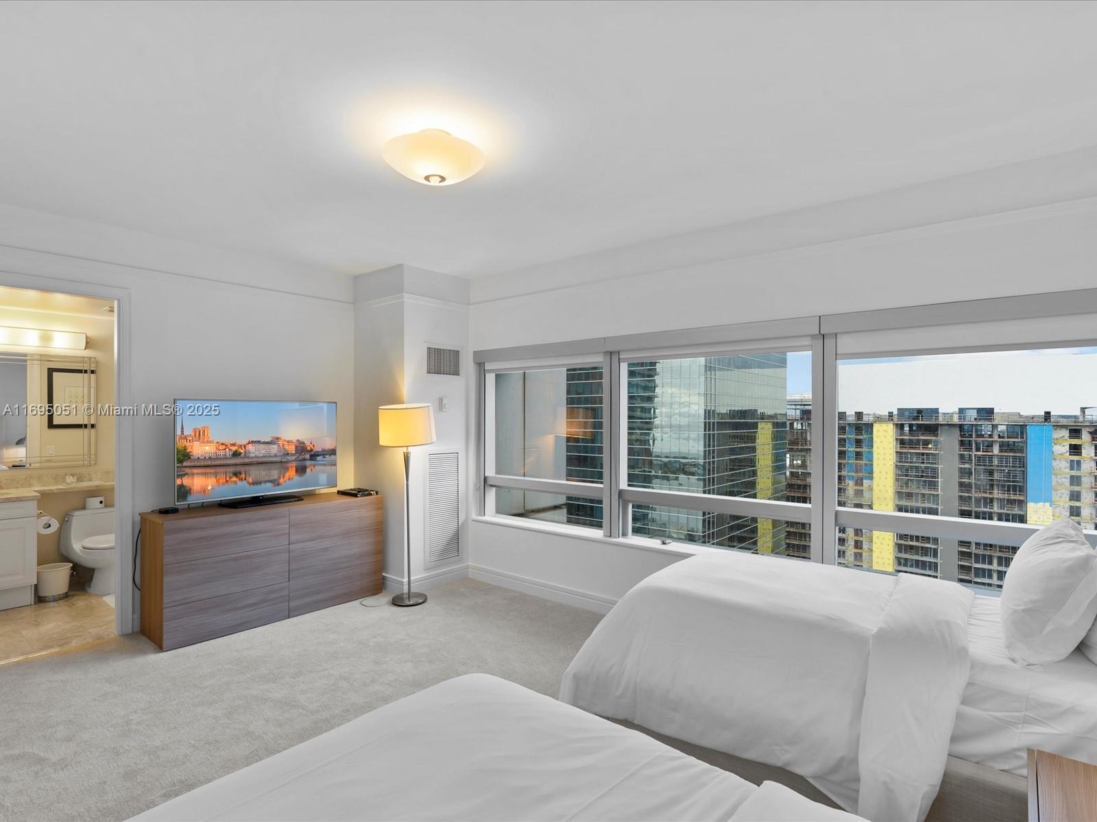 1435 Brickell Avenue, Unit 3601 Miami, FL 33131 - Photo 31 of 42 a bedroom with furniture and large windows