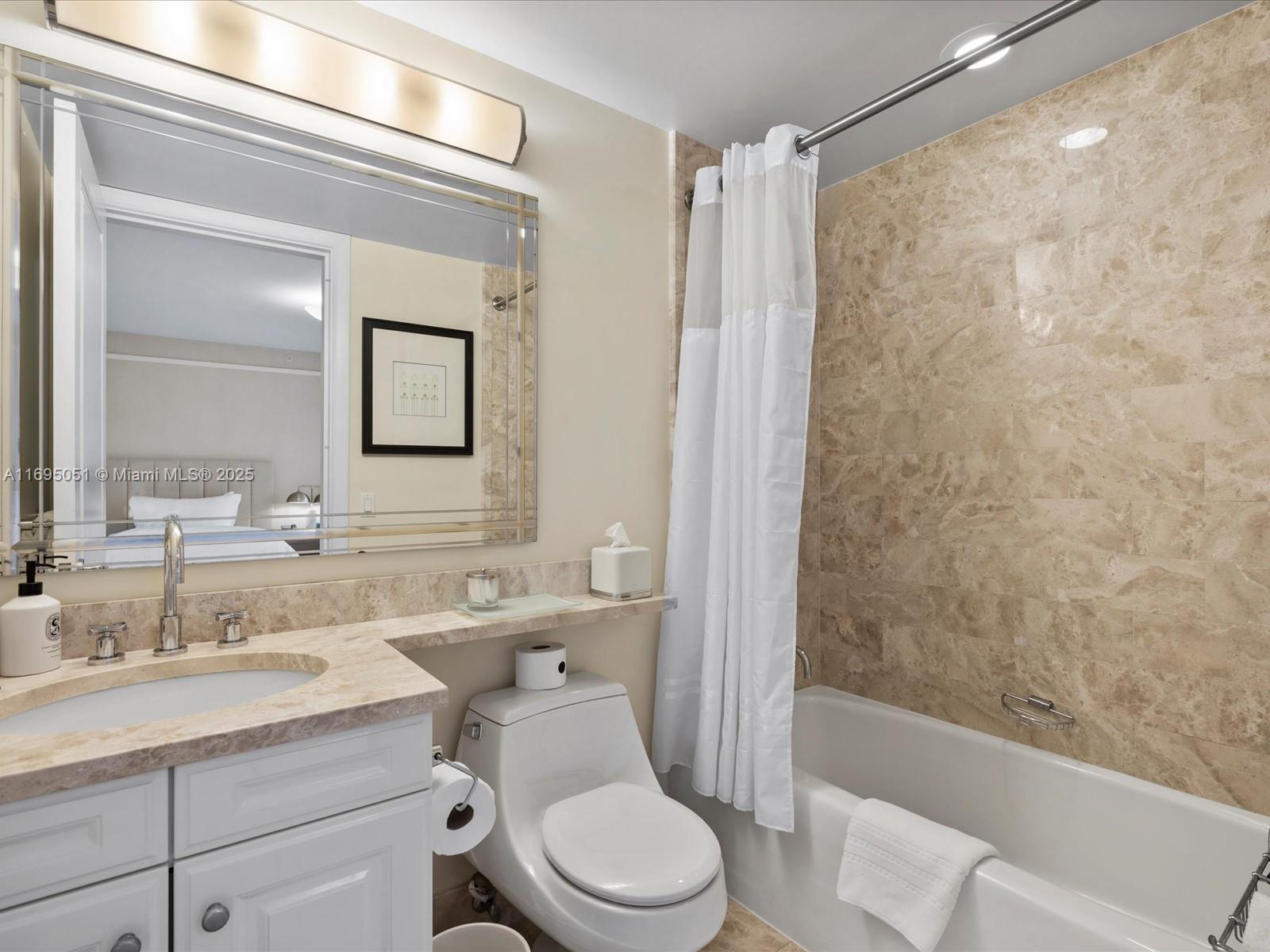 1435 Brickell Avenue, Unit 3601 Miami, FL 33131 - Photo 33 of 42 a bathroom with a sink a toilet and shower