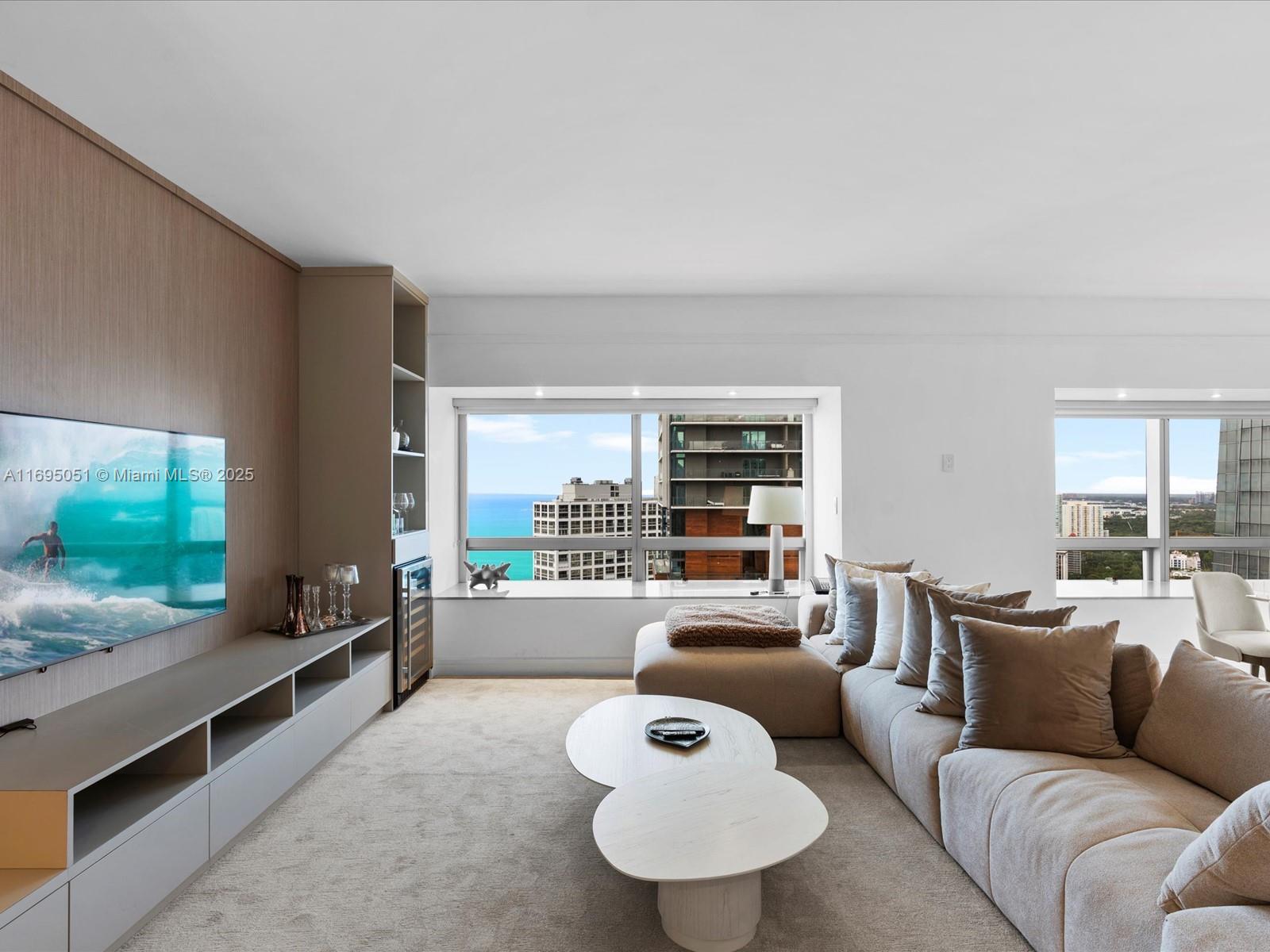 1435 Brickell Avenue, Unit 3601 Miami, FL 33131 - Photo 9 of 42 a living room with furniture and a flat screen tv