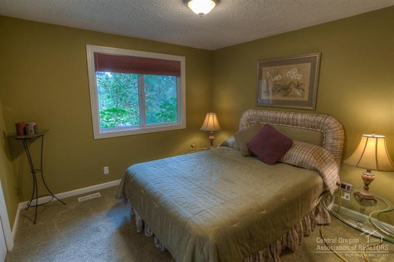 60192 West Ridgeview Drive Bend, OR 97702 - Photo 15 of 25 a bedroom with a bed and wooden floor
