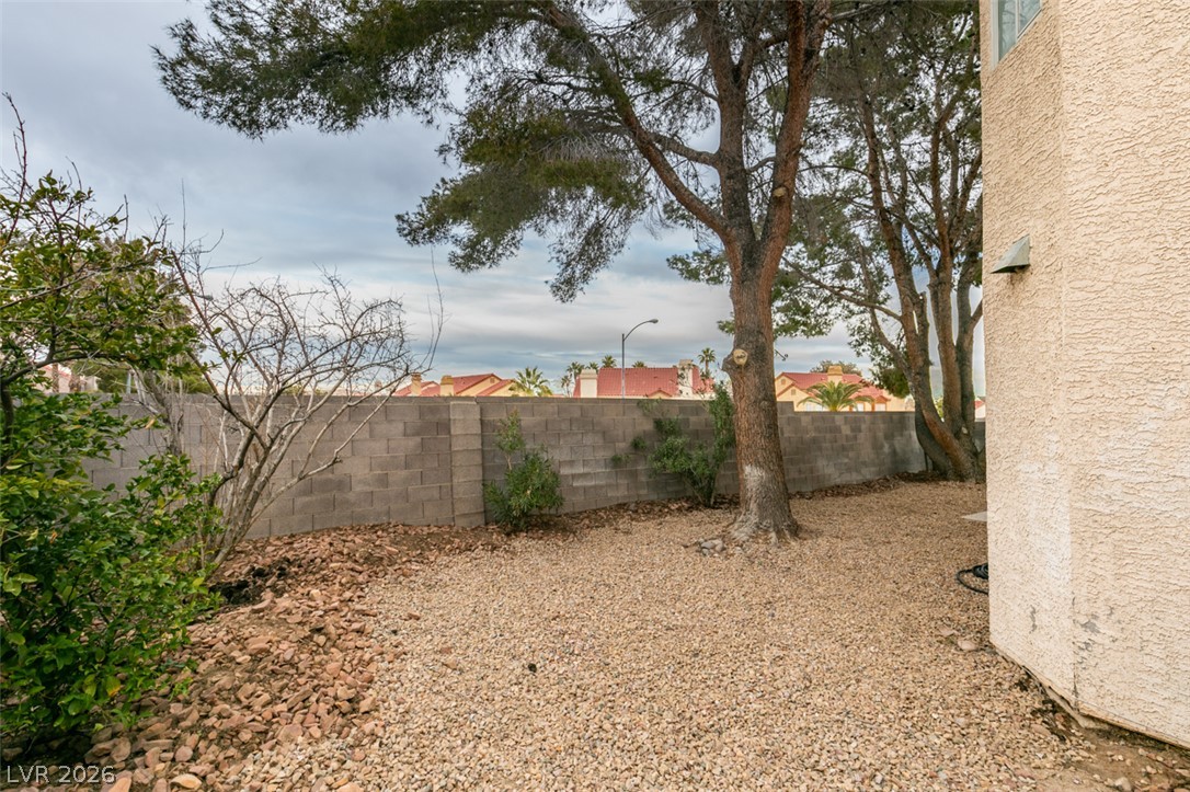 1738 Toltec Circle Henderson, NV 89014 - Photo 20 of 46 A low-maintenance yard features ample gravel, providing a clean and tidy outdoor space.