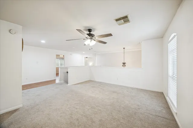 a view of a livingroom with a chandelier fan