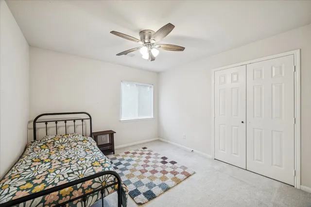 a bedroom with a large bed and a window