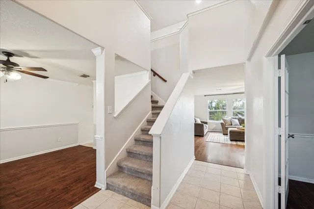 a view of entryway and hall with wooden floor