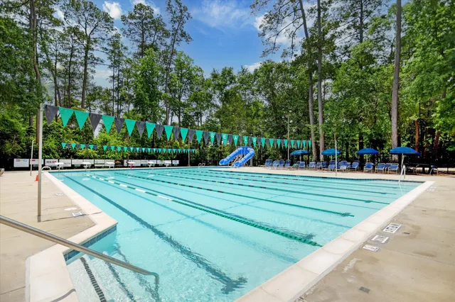 a view of a swimming pool with a table and chairs