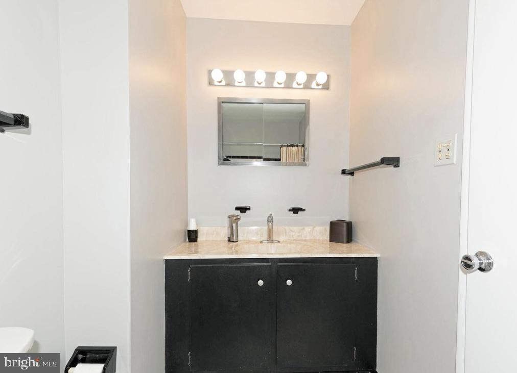 403 Merryman Road Annapolis, MD 21401 - Photo 17 of 31 a bathroom with a double vanity sink and mirror