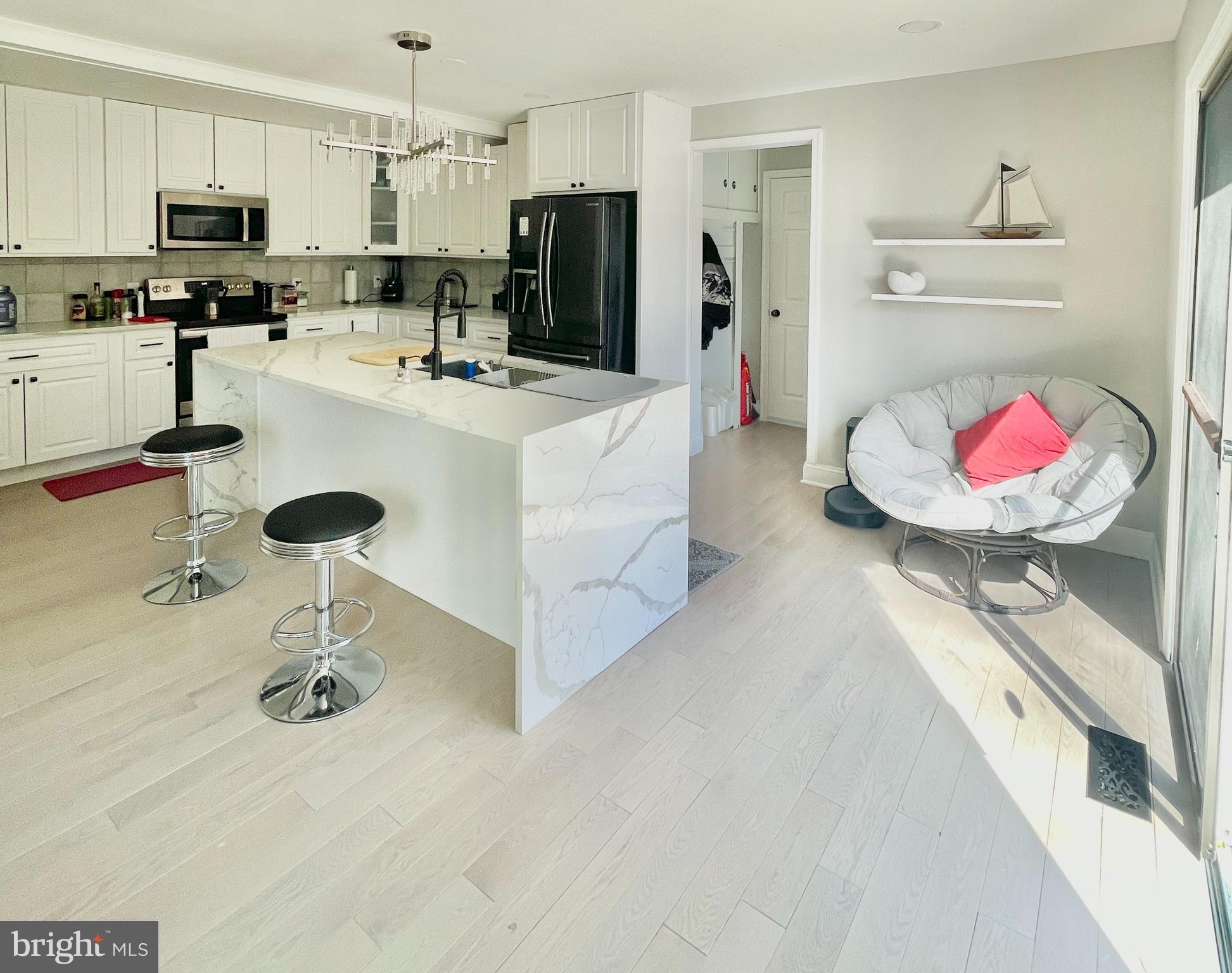 403 Merryman Road Annapolis, MD 21401 - Photo 7 of 31 a kitchen with stainless steel appliances kitchen island a refrigerator sink and stove