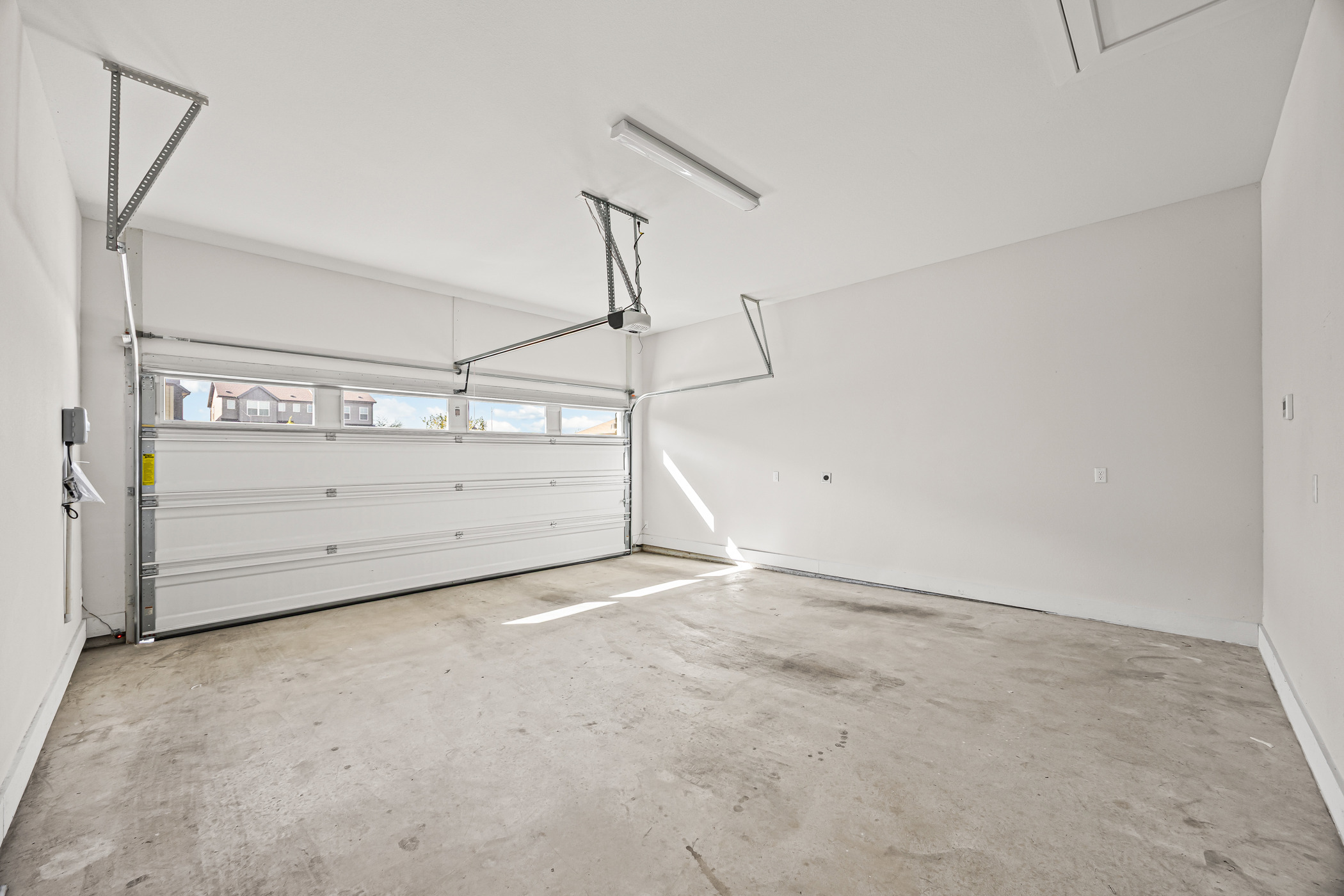 5806 Rangeland Road Austin, TX 78747 - Photo 30 of 34 A spacious, well-lit garage features a gleaming white overhead door and ample storage.