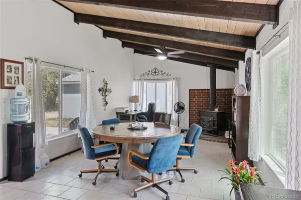 a kitchen with stainless steel appliances granite countertop a refrigerator a sink dishwasher a stove and white countertops with wooden floor