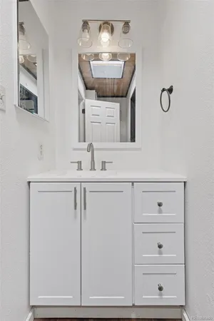a bathroom with a sink toilet and mirror
