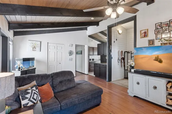 a kitchen with stainless steel appliances granite countertop a refrigerator a sink dishwasher a stove with wooden cabinets