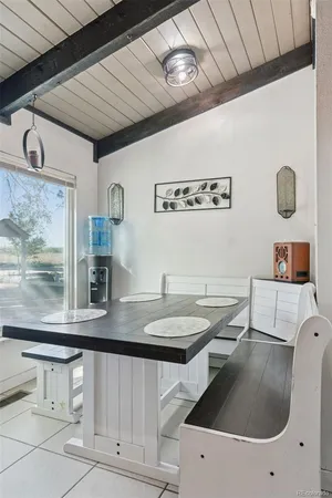 a bedroom with a bed a dresser next to a window