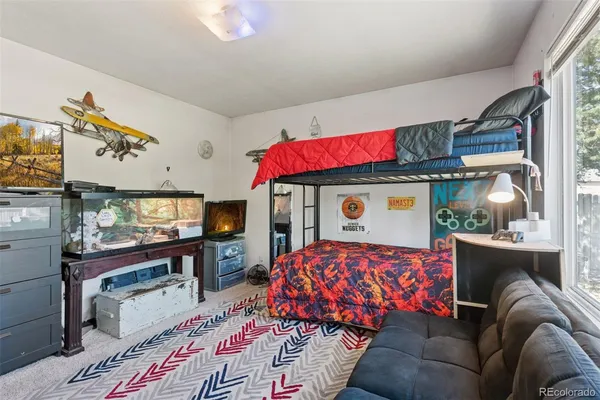 a bed sitting in a bedroom next to a window