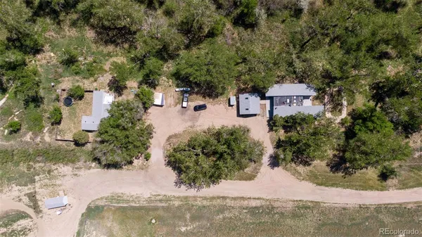 an aerial view of a house with a yard