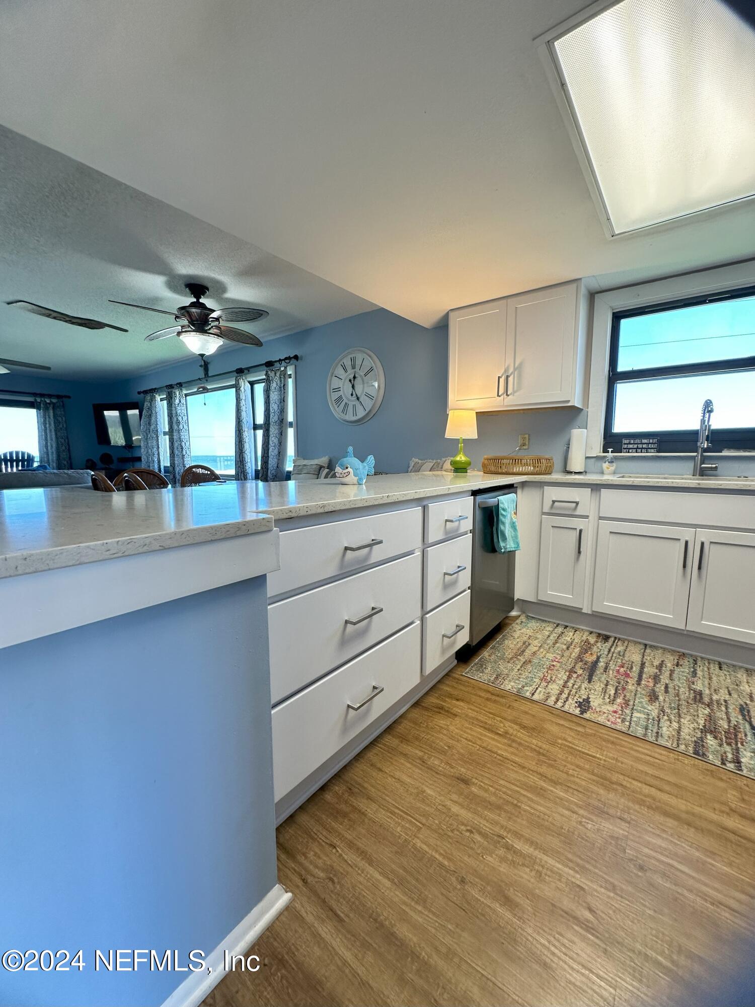 2100 Ocean Shore Boulevard, Unit 3010 Ormond Beach, FL 32176 - Photo 6 of 32 a large kitchen with cabinets and wooden floor